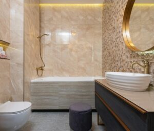 Bathroom with brushed brass faucet, black towel bar, and chrome mirror, showing mixing metals in bathroom design