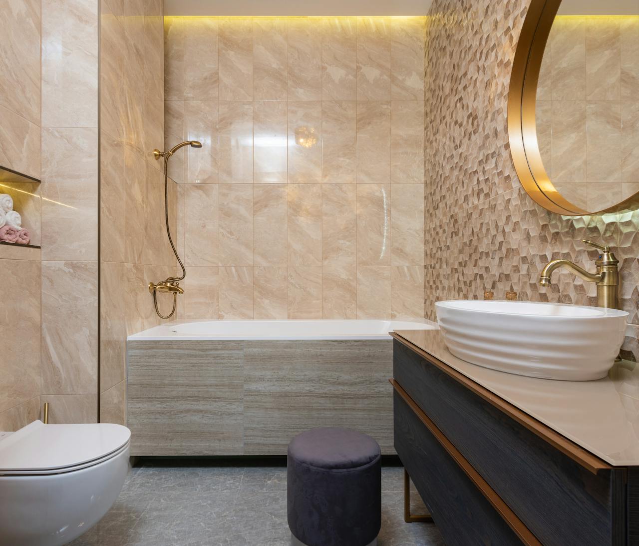 Bathroom with brushed brass faucet, black towel bar, and chrome mirror, showing mixing metals in bathroom design